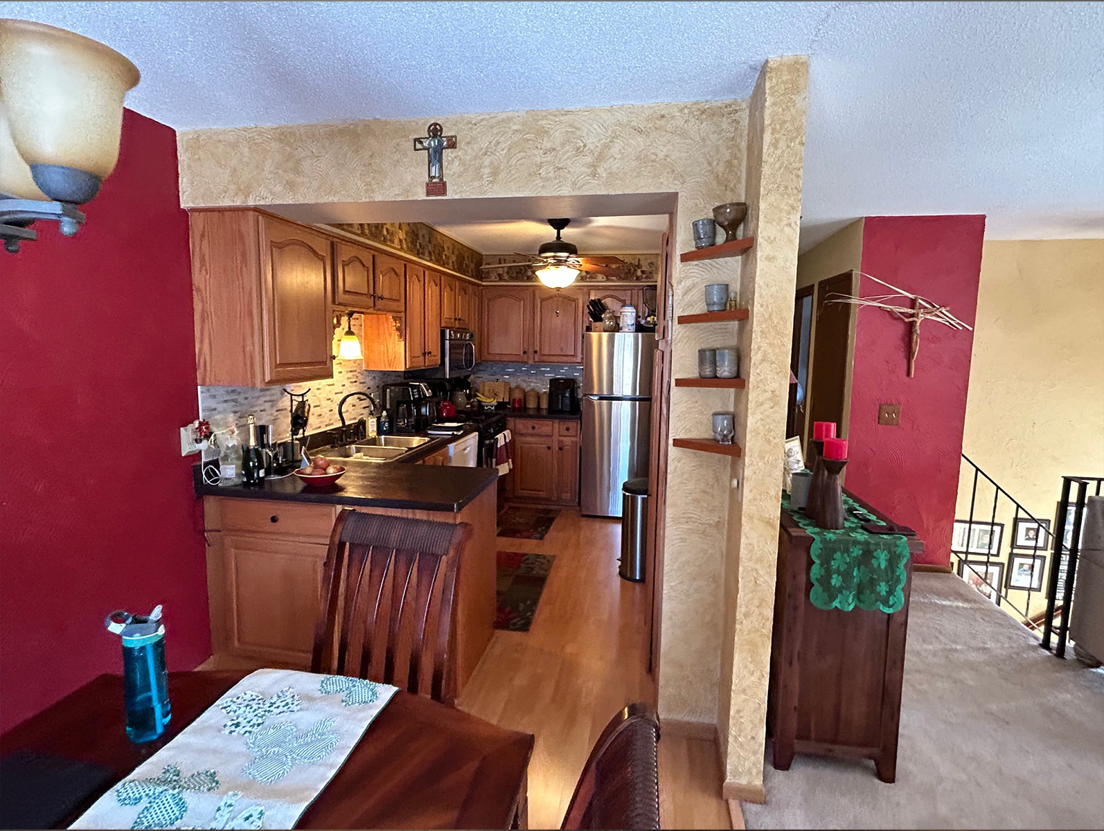 Original kitchen with red walls and dark wood cabinets before renovation